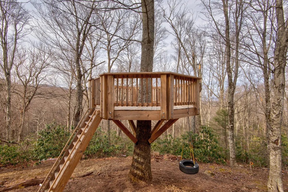 A whimsical backyard scene highlighting a sturdy treehouse with an attached ladder and a playful tire swing hanging from a nearby tree. Children are seen playing, exploring, and engaging in imaginative adventures amidst the wooded landscape.